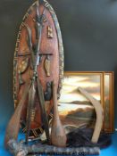 A collection of decorative tribal artefacts to include spears, shield and two African watercolours.