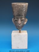 An Egyptian pottery bust of a Pharaoh on stone stand, 14cm tall excluding base.