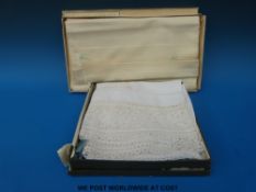 A linen and lace tablecloth in original box c1920 together with a further embroidered example in
