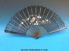 A 19thC ebonised lace fan, the leaves hand decorated to show a fledgling amongst dog rose,