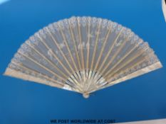 A large mother-of-pearl, bone and fine lace fan with hand-painted bird decoration,