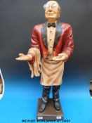 A decorative model butler with tray,