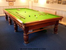 A full size snooker table and accessories including cues and rack, balls,