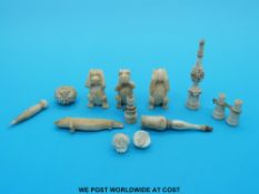 A collection of small ivory / bone items to include three wise monkeys and three miniature