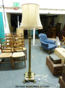 A brass Corinthian column standard lamp with lions paw feet.