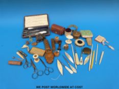 A quantity of mainly sewing-related collectables including novelty owl needle case, tape measures,