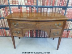 A Georgian mahogany bow front desk or side table fitted three drawers and raised on square tapering