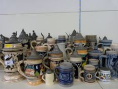 A large collection of various sized Bavarian steins including some small/miniature examples,