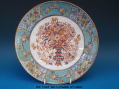 An Japanese clobbered enamelled plate with floral decoration (26cm diameter)