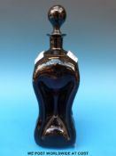 An amethyst coloured glass decanter of waisted form