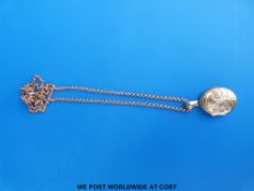 A yellow metal locket and chain,