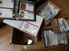 A large quantity of first day covers and loose all world stamps