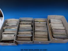 Four boxes of postcards including topographical, ecclesiastical buildings,