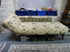 A late 19thC chaise longue with spindle back and raised on turned legs