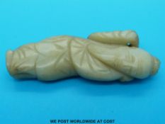 A jade figure of a sage with russet inclusions (8cm long)