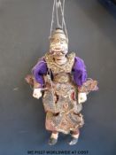 An Indonesian carved wooden puppet in traditional dress (40cm tall)