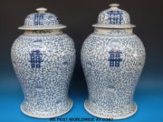 A pair of large Chinese blue and white jars with happiness Shou characters and stylized floral