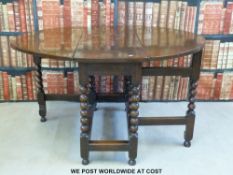 An oak drop leaf table with bobbin turned legs and drawer to one end (l106 x h73cm)