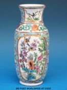 A Chinese Canton vase with bird and flower decoration on blue ground (14.