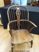 An antique elm seated Windsor chair with looped stick back and pierced splat