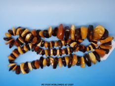 An amber necklace of over 100 irregular pieces,