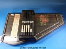 An autoharp with rose decoration in original box