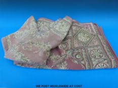 A tablecloth/ throw with floral design on pink ground