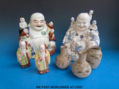Two Chinese seated Buddhas with children and two Chinese immortal figures