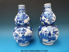 A pair of 19thC Chinese blue and white double gourd vases with 100 Antiques style decoration.