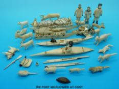 A quantity of Alaskan or Greenland Inuit carved ivory figures and animals including a large sledge