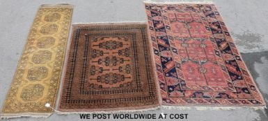 Three wool rugs, one geometric on pink ground (190cm x 118cm)  ,