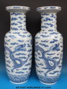 A pair of 19thC Chinese blue and white rouleau vases with dragon decoration (61cm tall)