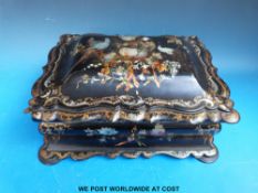 A Japanese lacquer box of bombe form extensively gilt decorated and inlaid with mother of pearl.