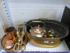 A collection of brass and copper ware including a brass cooking pot with carrying handle,