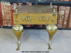 A Georgian brass footman with sweeping front legs