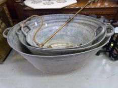 Three graduated tin baths,