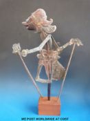 A 19thC carved wood Wayang Kulit Indonesian puppet depicting Menak Jing.