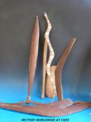 A collection of Aboriginal boomerangs, throwing clubs, snakes, hooked implement,