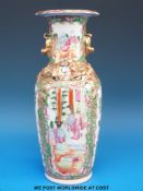 A Chinese famille rose vase enameled and gilt decorated with figural scenes (26cm tall)