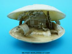 A Japanese ivory oyster shell carving with working waterwheel attached to a mill,