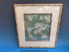 A Chinese silk embroidery depicting flowers and bats,