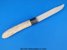 A Balinese ivory knife with ornately carved figural handle and white metal collar (36cm long)