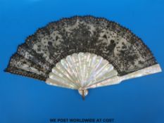 A 19thC mother-of-pearl, silk and lace fan,