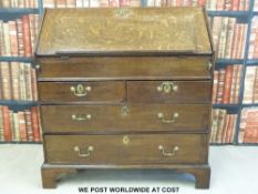 A Georgian oak bureau raised on bracket feet (w93 x d54 x h100)