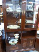 A Chinese dark elm display cupboard with glazed top diplay unit having asymmetric shelving over
