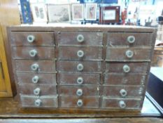 A set of miniature haberdashery/collector's drawers comprising 18 drawers (w32.5 x d22.