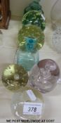 A collection of bubble paperweights and two glass scent bottles