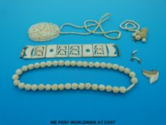 An ivory bracelet with 9ct gold clasp, carved ivory necklace and pendant,