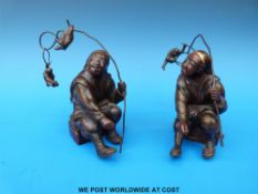 A pair of Japanese Meiji period bronze figures in the form of two Noh actors both holding sticks