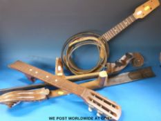 A collection of stringed instruments for parts or the restorer, comprising a ukulele banjo,